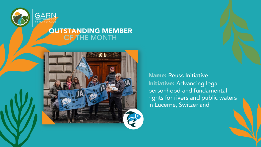 Reuss Initiative members hold blue flags reading 'JA' outside Lucerne parliamentary building