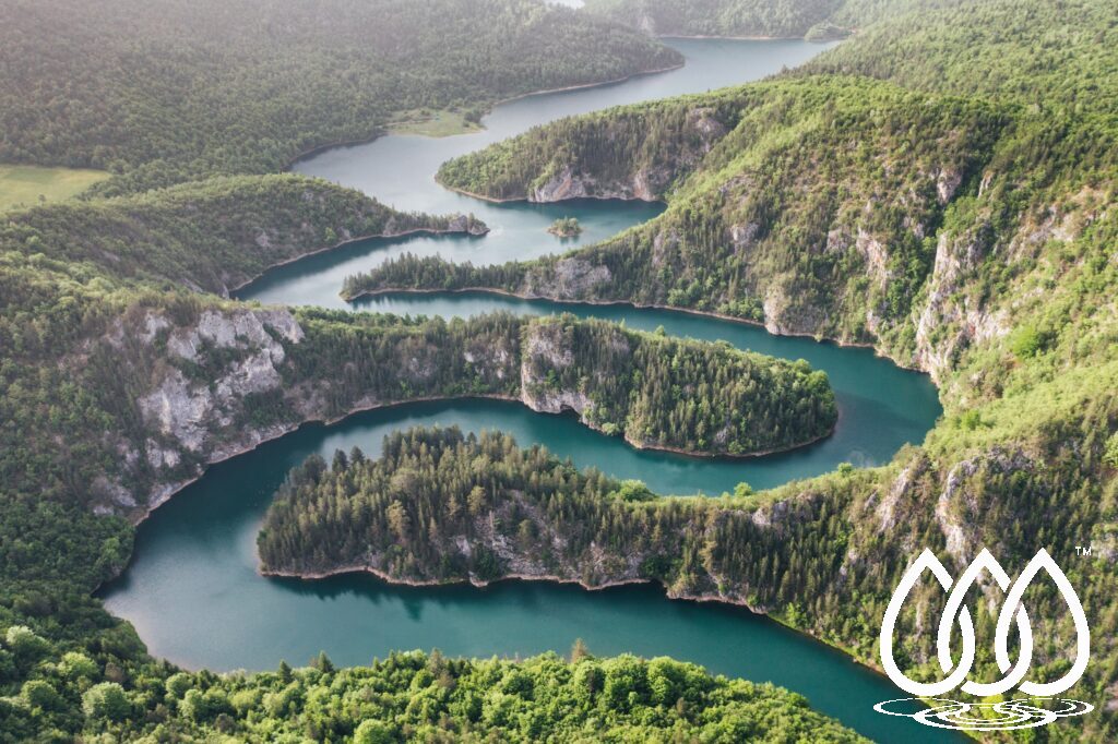 Aerial view of winding river through green landscape illustrating watershed governance at catchment scale